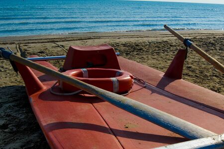 summer scene with sand and small boat at seasideの写真素材
