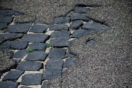 degaradeted asphalt revealing the old pavement underneathの写真素材