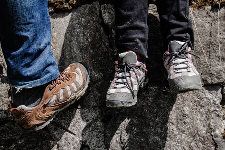 hiking shoes with stone wall in backgroundの写真素材