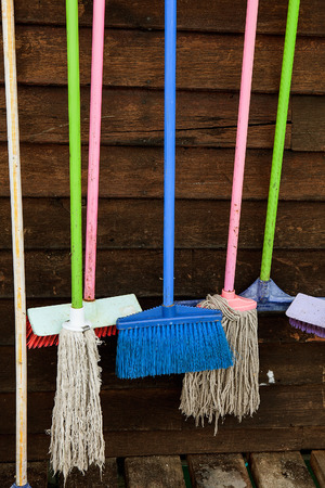 Set of cleaning equipment on a wooden wallの写真素材