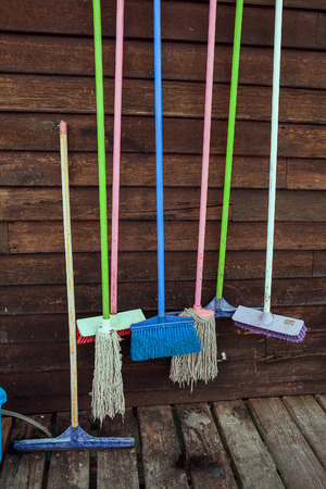 Set of cleaning equipment on a wooden wallの写真素材