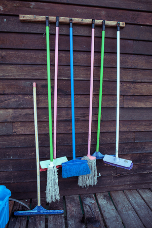 Set of cleaning equipment on a wooden wallの写真素材