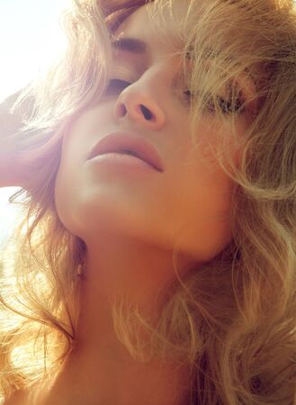 magnificent outdoor portrait of a beautiful young woman with perfect skin closeupの写真素材