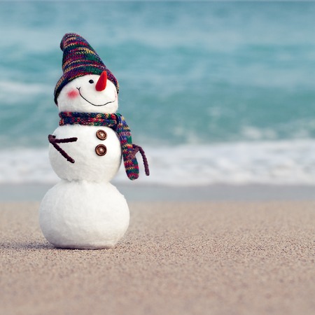 Smiling snowman on the sea beach. Summer holidays or New Year conceptの写真素材