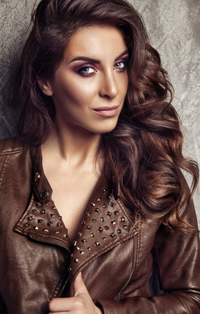 Beautiful woman face close up portrait young studio on grayの写真素材