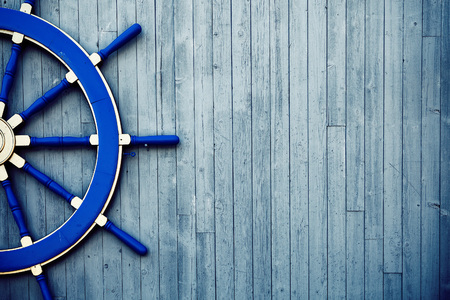 Old Vintage Blue Wooden Helm Wheel on the wallの写真素材