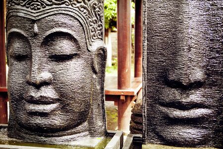 Rough stone Buddha face, statue on Bali marketの写真素材