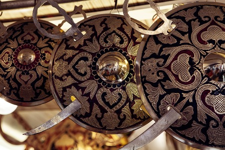 row of shields and swords in indian marketの写真素材