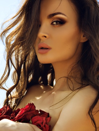 Beauty Fashion Model Girl Portrait with Red Rosesの写真素材