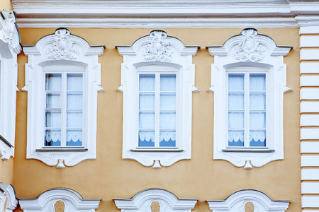 Close up still life detail view of an old stone building with intricate decorative detail. Classic architecture background. The facade of a historic building, designed in traditional old Russian styleの写真素材