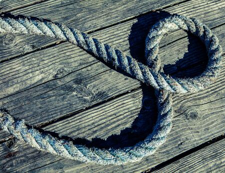 marine rope on weathered old wood background