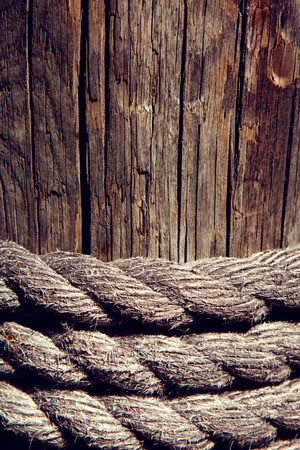 marine rope on weathered old wood background.の写真素材