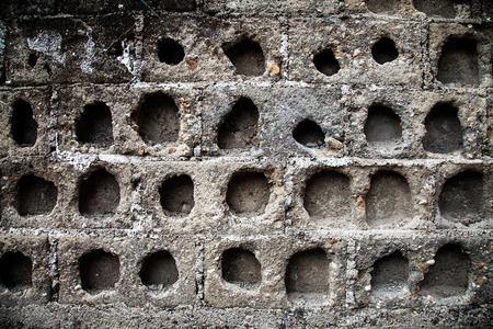 stone wall texture with holes, rough background.