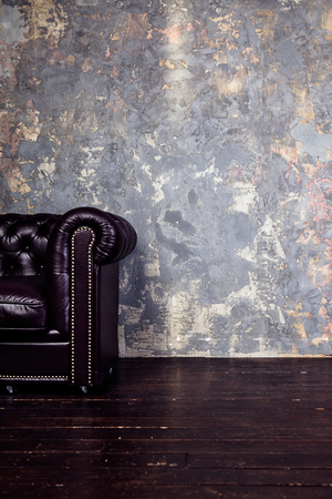 sunny studio with brown leather sofa detail in sun raysの写真素材