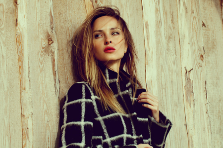 season and people concept - Autumn portrait of girl. Outdoor beauty portrait woman, fashion model, street style. wood background.の写真素材