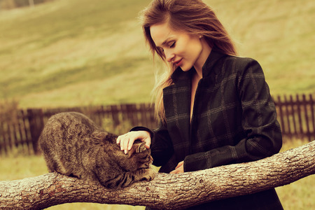 autumn portrait happy smiling woman holding a cat.の写真素材