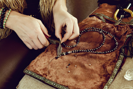 Jeweler at work in jewelery workshop. Handmade of accesoriesの写真素材