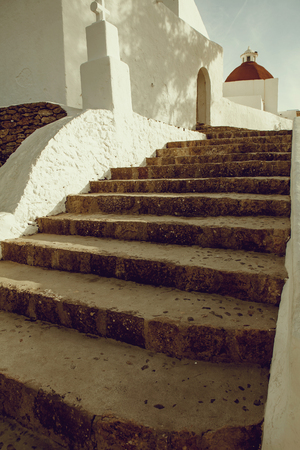 stone stairs on entrance of white old church in small Mediterranean city.の写真素材