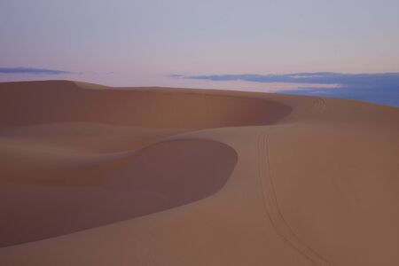Desert landscape on sunrise in Vietnam. Soft sunlight over ridges and shapes of sand dunes