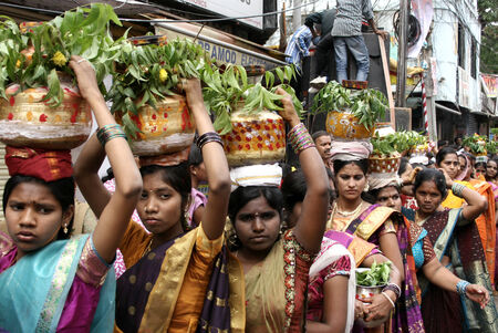 Secunderabad,India-July 28,2013-Hindu devotees carry the Bonam to the mahankali temple,as an offering to the goddess, during bonalu festival Annual festival event のeditorial素材