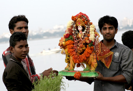 Hyderabad,Ap,India-October 12,2013 -Hindu devotess perform puja before immersing Durga as the final...