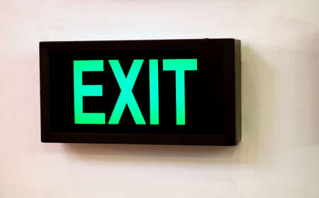 Close-up view of Electric illuminated Exit Sign board in a public place