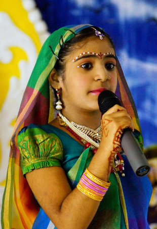 HYDERABAD,INDIA-AUGUST 24,2019: Indian Hindu Girl Sita,11,Nampally sing prayer song,a religious ritual,on Krisnastami festival celebration in God Krishna templeのeditorial素材