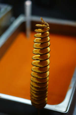 Close-up view of Indian street food making of twisted or tornado photo chipsの写真素材