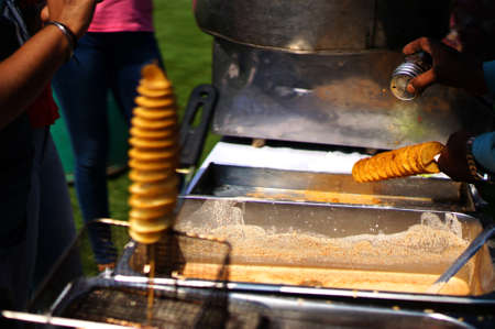 view of making Indian street food twisted or spiral or tornado photo chipsの写真素材