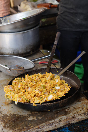 Close-up view of Indian street vender make onion  pakora snack in outdoors