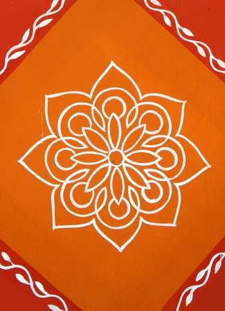 Close-up view of Indian Hindu traditional rangoli drawing on the wall of rural house, for use as backgroundの写真素材