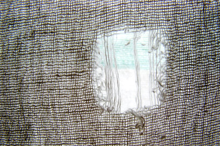 Close-up view of hole in textile or cloth for use as background
