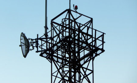 View of communication tower against blue skyの写真素材