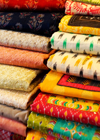 Close-up view of Indian woman wear sarees or saris stacked retail shop display