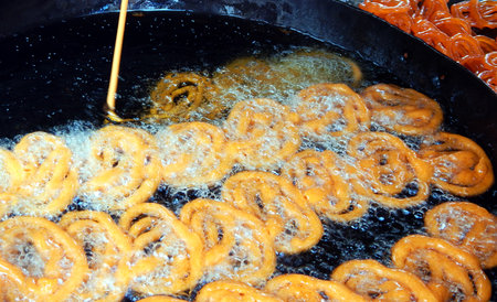 Close-up view of making Indian street food Jilebi, a popular sweet