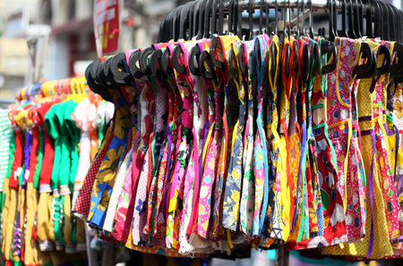 Close-up view of Indian female children dresses in diplay on hangers in the marketの写真素材