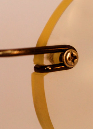 Close up of a safety pin on a white background with reflection.の写真素材