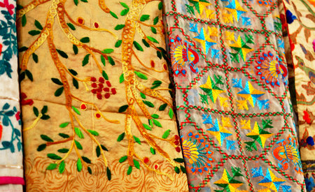 Close-up view of Indian woman wear embroidered or with needle work saris or sarees in shop displayの写真素材