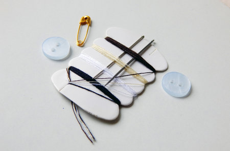 view of stitching set fot emergency use colorful threads, needles and buttons