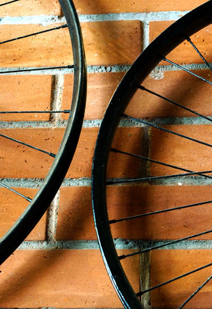 rim of bicycle wheel with spokes as background in interiors on brick wallの写真素材