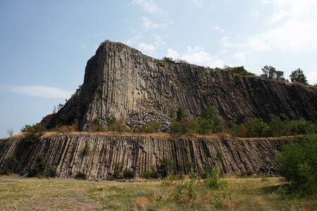 Geological stone hill with basaltic petagonal columnsの写真素材