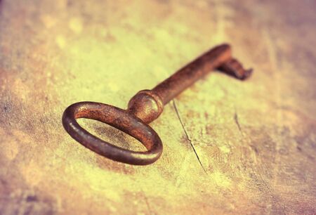 Old rusty lost key lying on the groundの写真素材