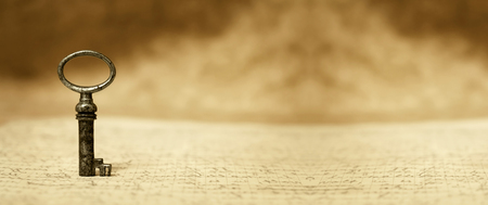 Old key standing on a letter - vintage bannerの写真素材