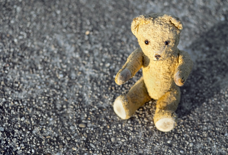 Childhood concept banner - cute vintage toy bear sitting on the groundの写真素材