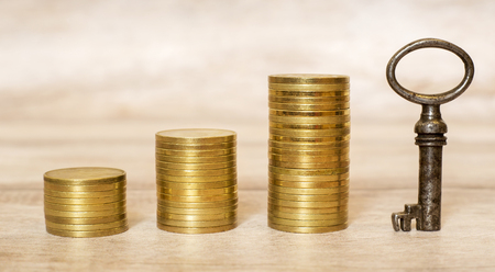 Money savings and growing - web banner of gold coins and success keyの写真素材