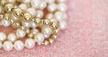Beautiful white and golden pearls jewelry gift close-up - web banner with blank, copy spaceの写真素材