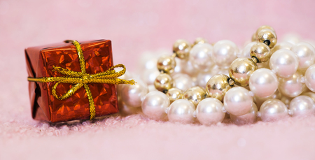 Web banner of birthday gift box and pearls for females on pink backgroundの写真素材