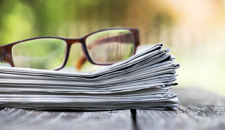 Morning news concept - newspaper and glasses with copy space