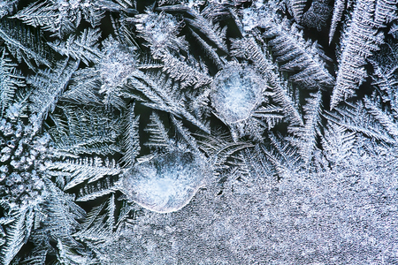 Frozen ice flower on a window on cold winter - close-up backgroundの写真素材