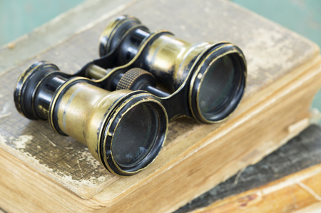 Binoculars on books, searching wisdom, knowledgeの写真素材
